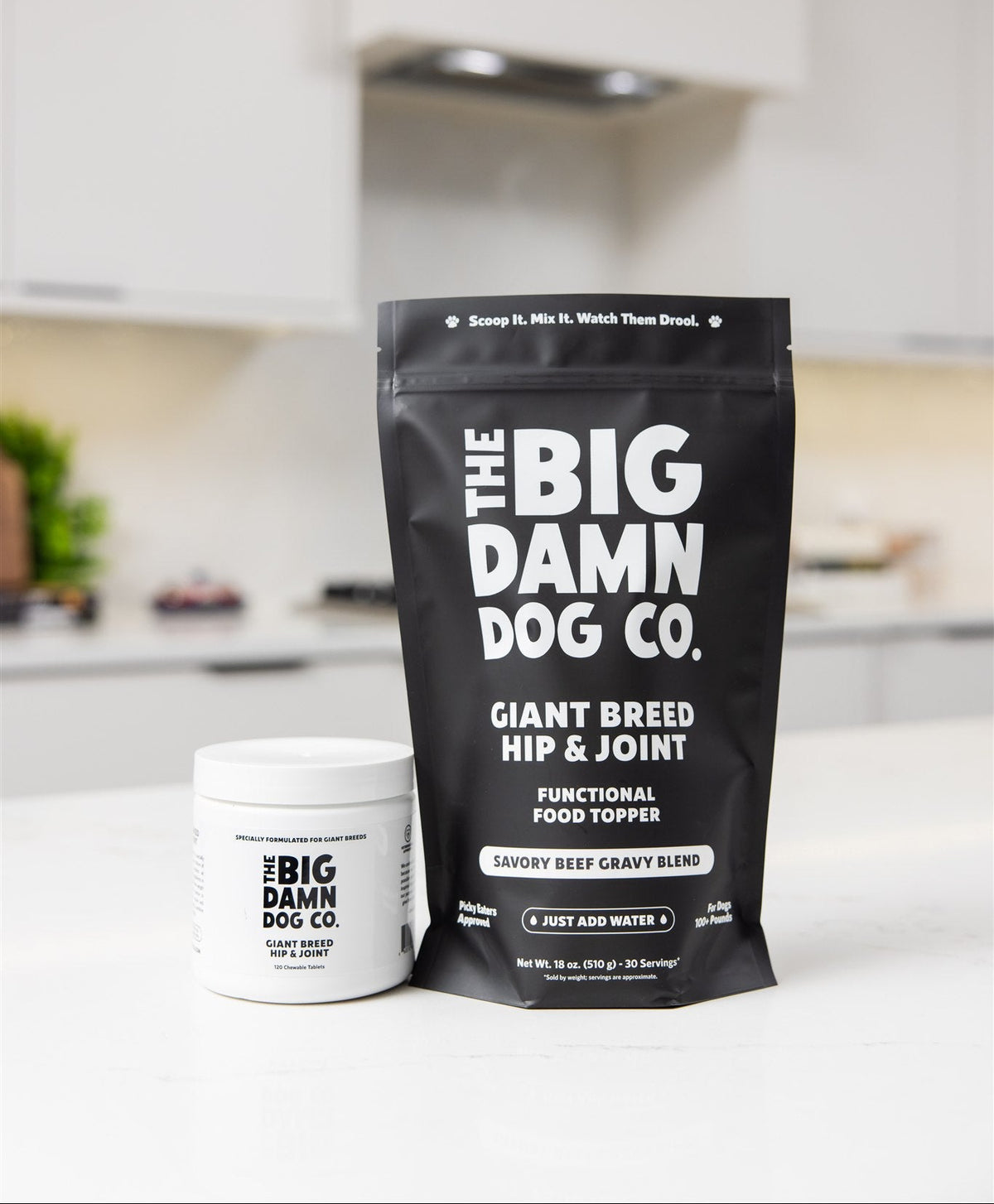 The Big Damn Dog Co. Giant Breed Hip & Joint supplement packaging on a kitchen counter.